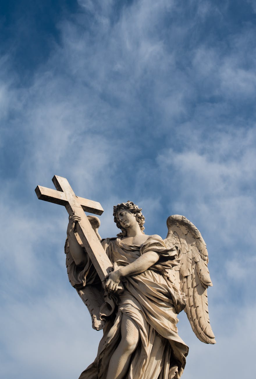 angel carrying the cross statue
