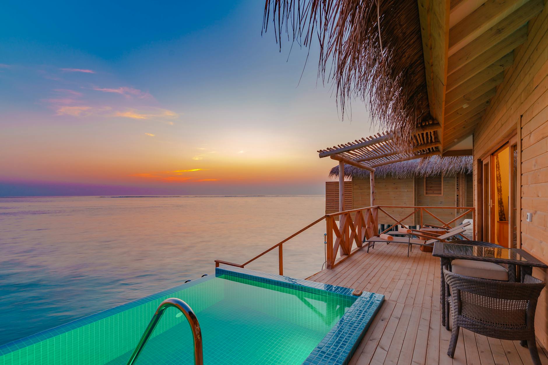 overwater villa at sunset in maldives
