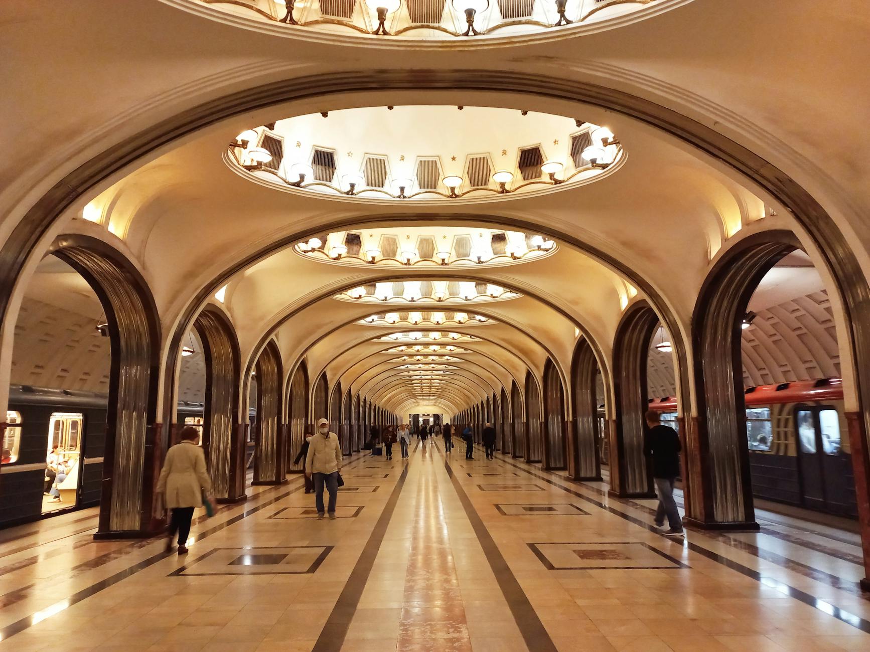 commuters at mayakovskaya underground station of moscow metro