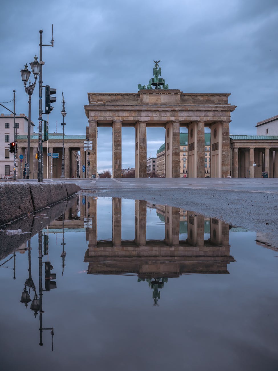 reflection of brandenburg gate in puddle