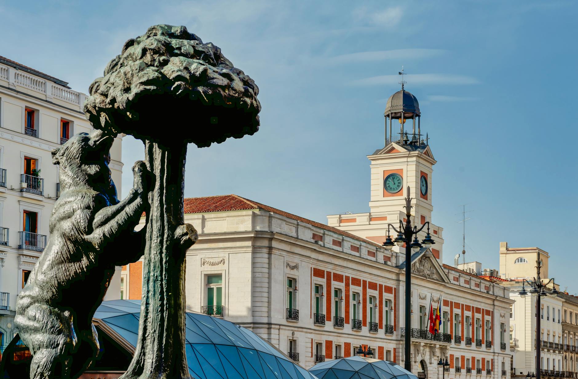 iconic puerta del sol with bear sculpture in madrid