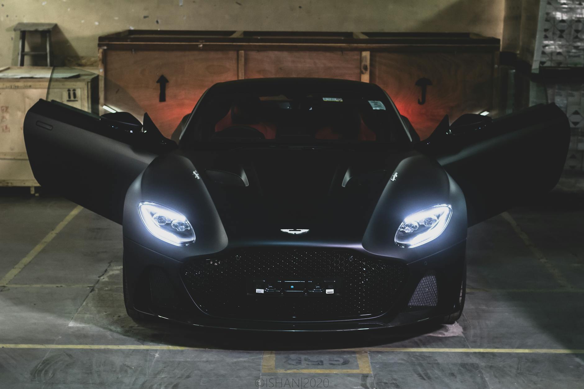 pexels-photo-6952776 a black aston martin in a parking lot