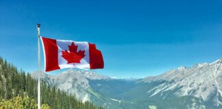 canada flag with mountain range view