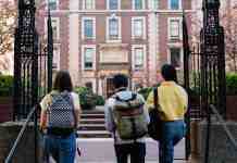 back view of people walking into a campus