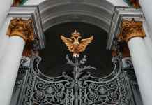 a gold double headed eagle on the gate of winter palace in st petersburg russia