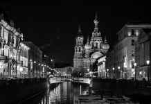 grayscale photo of building near body of water