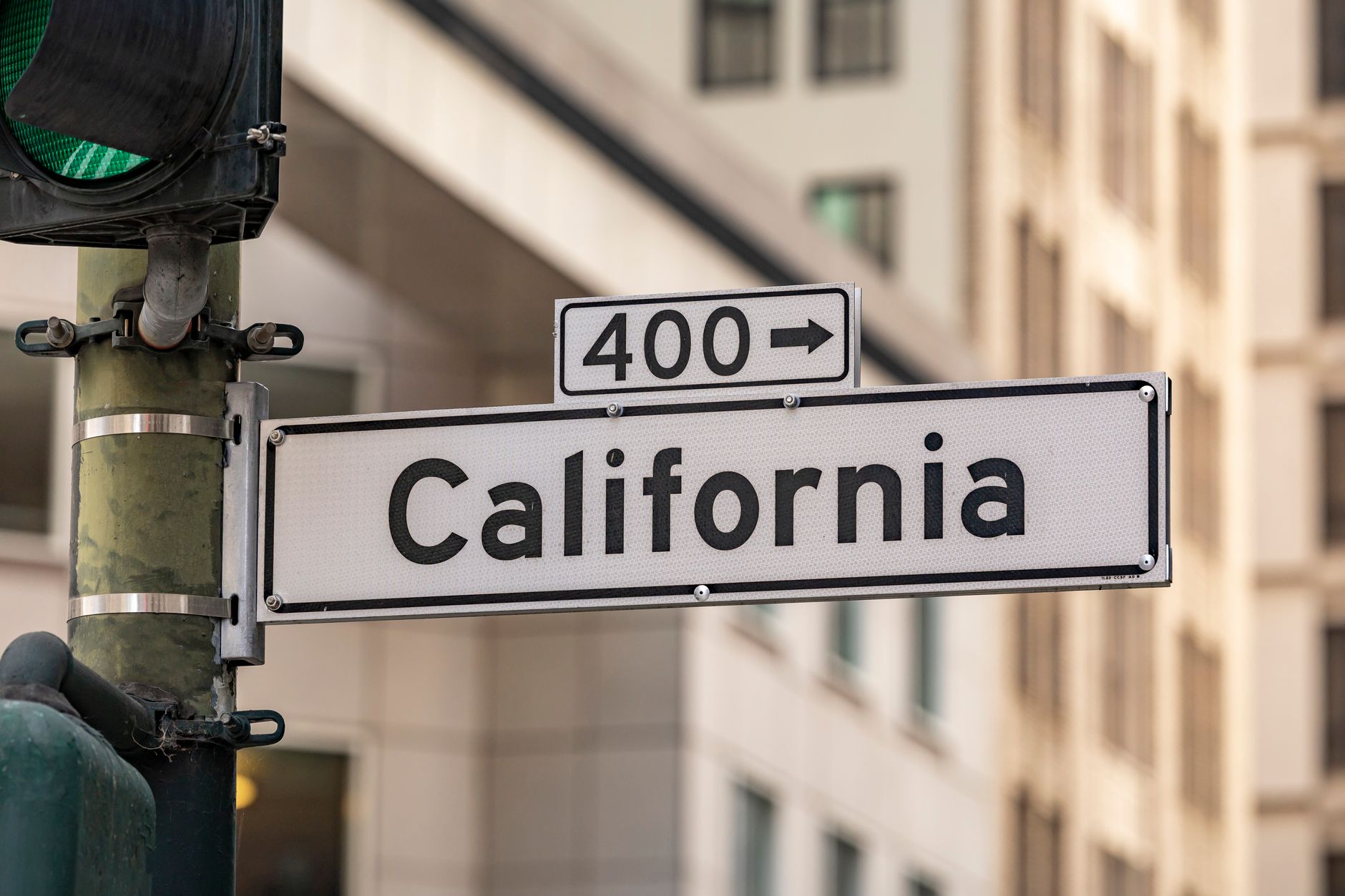 california street sign with traffic light in urban setting